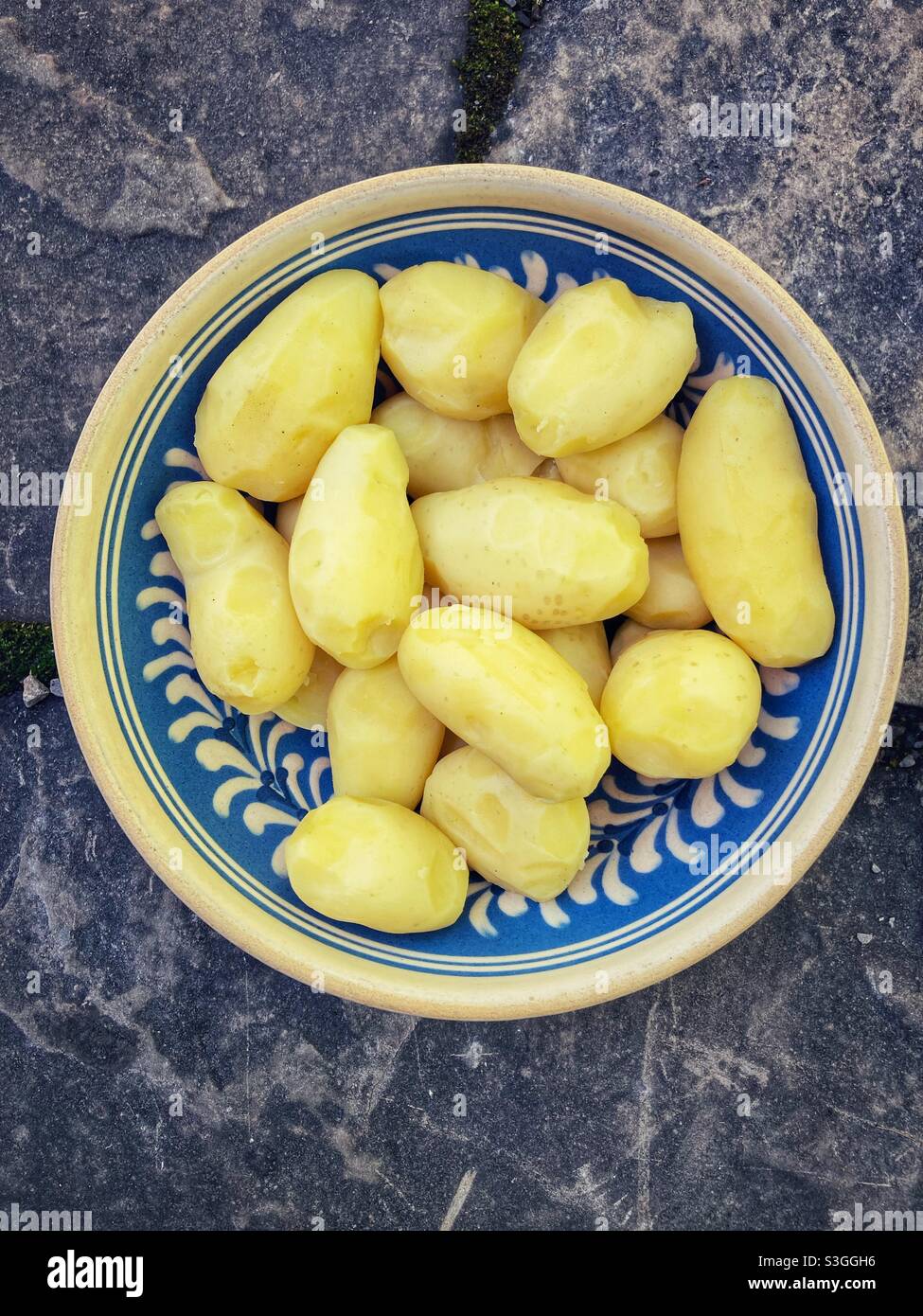 Peeled and cooked potatoes in a handmade bowl - Smartphone Captured Stock Image