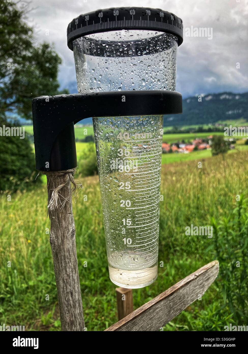 A raingauge with a Little Water in it in the German Alps - Smartphone Captured Stock Image