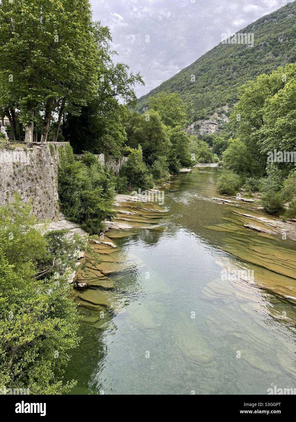 Hérault river bordered by walls and large boulders at Ganges and Montpellier, Occitanie, south of France - Smartphone Captured Stock Image