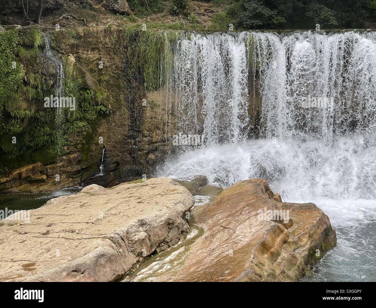 Large waterfall over La Vis river in Ganges and Montpellier, Occitanie, south of France - Smartphone Captured Stock Image