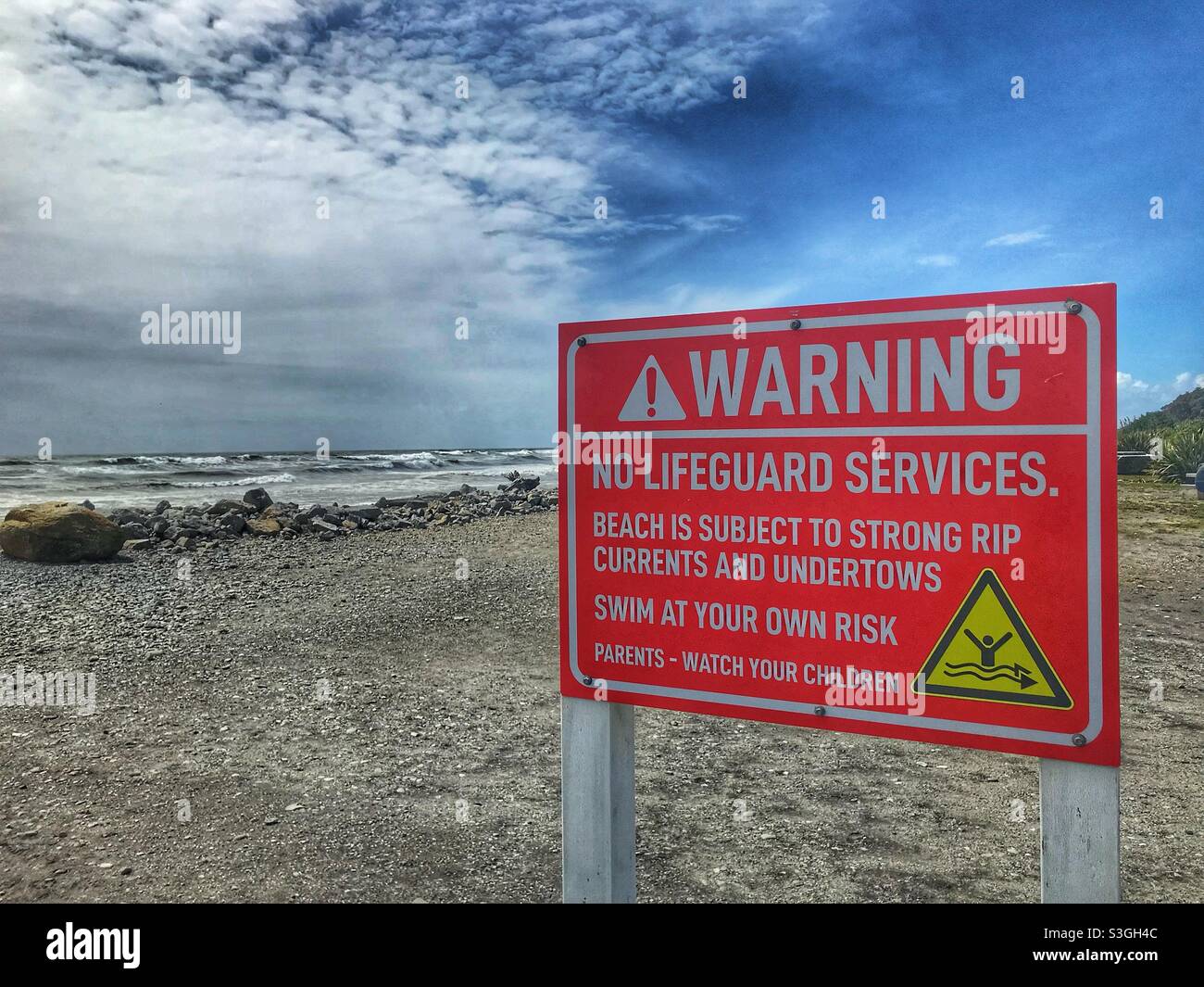 Warning sign on the beach at Hokitika, South Island, New Zealand - Smartphone Captured Stock Image