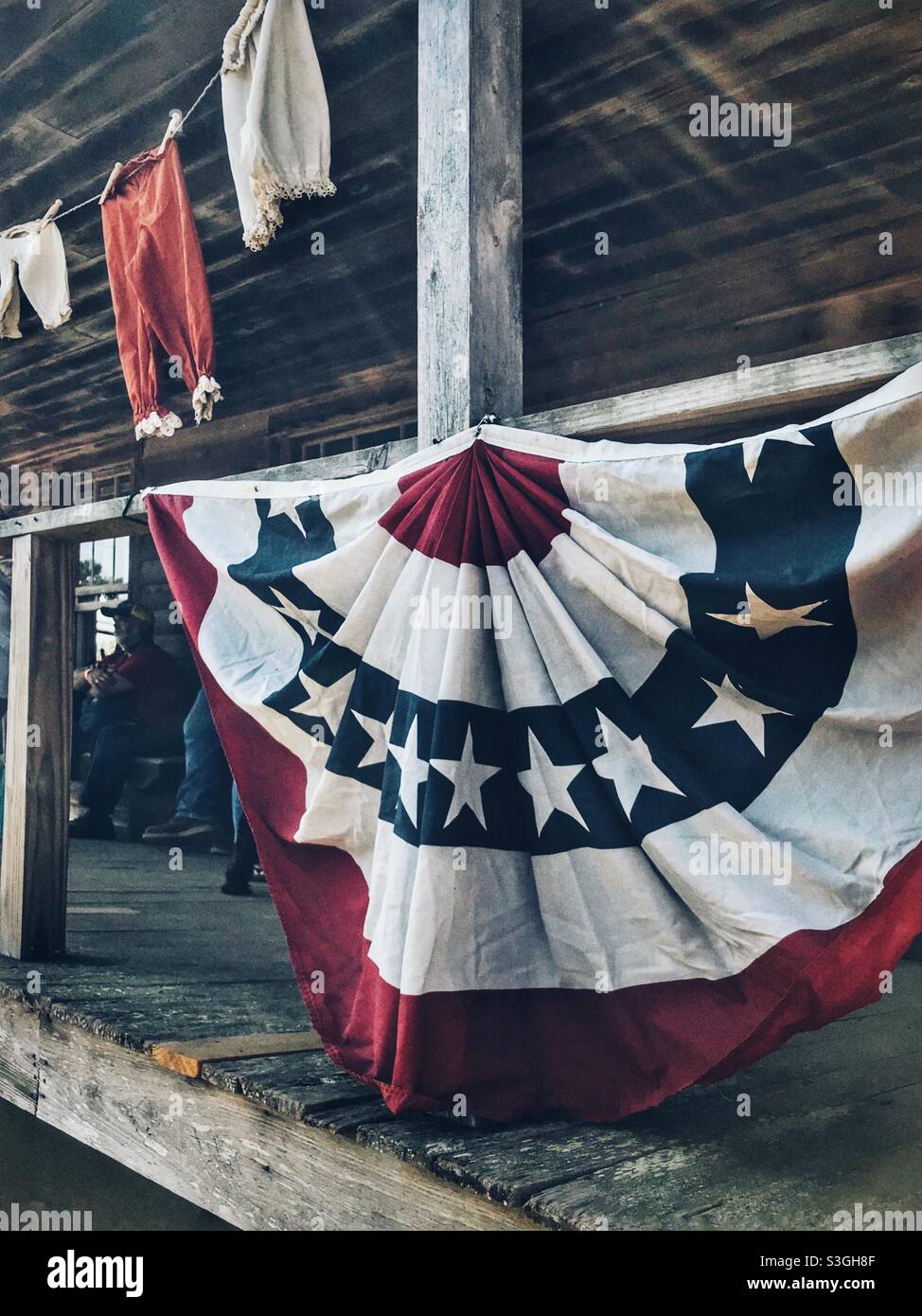 Red, white , and blue bunting at farmer’s 4th of July celebration - Smartphone Captured Stock Image