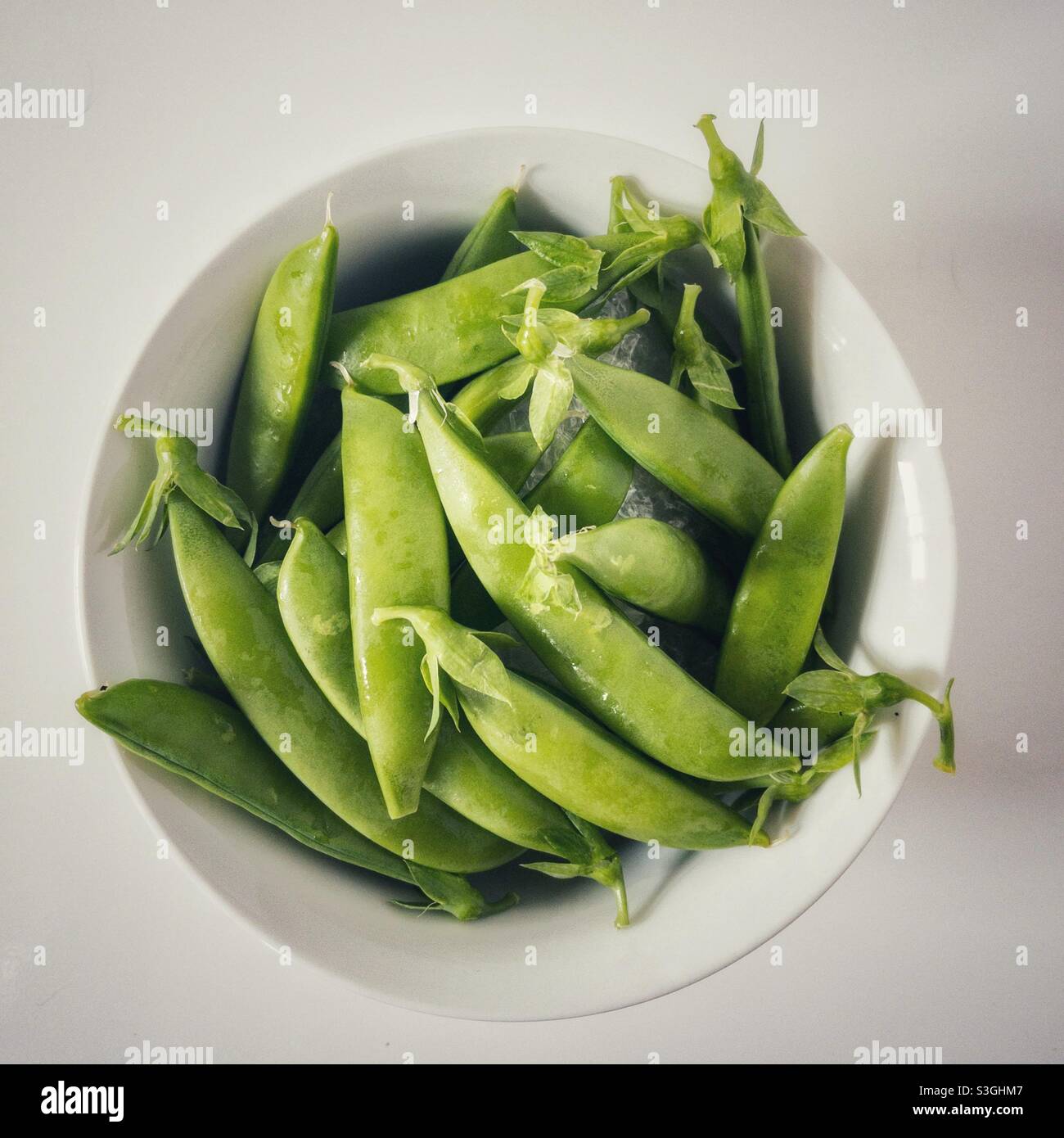 A bowl full of sugar snap peas. - Smartphone Captured Stock Image
