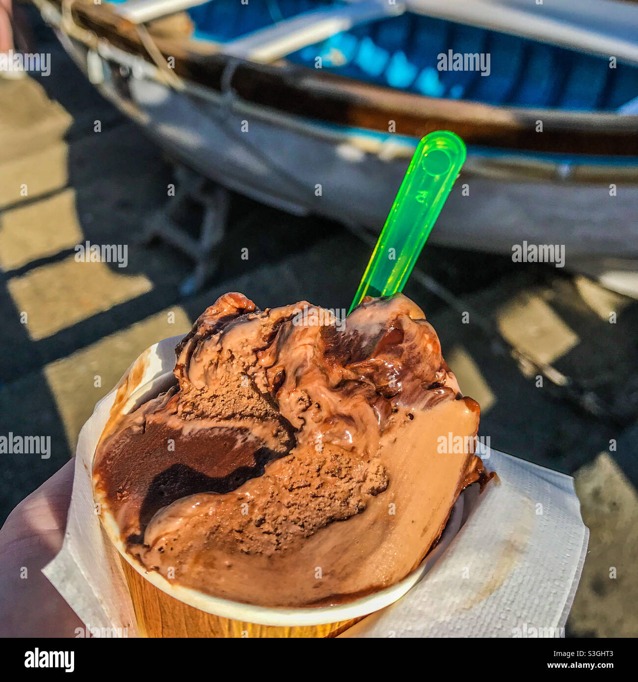 Chocolate icecream by a fishing boat Stock Photo Alamy