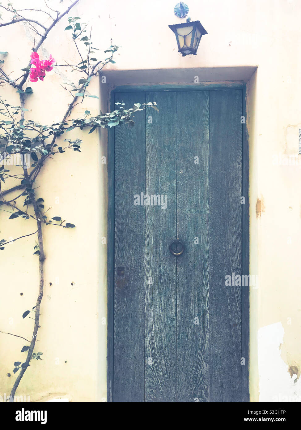 Colourful wooden door in yellow wall, Italy - Smartphone Captured Stock Image