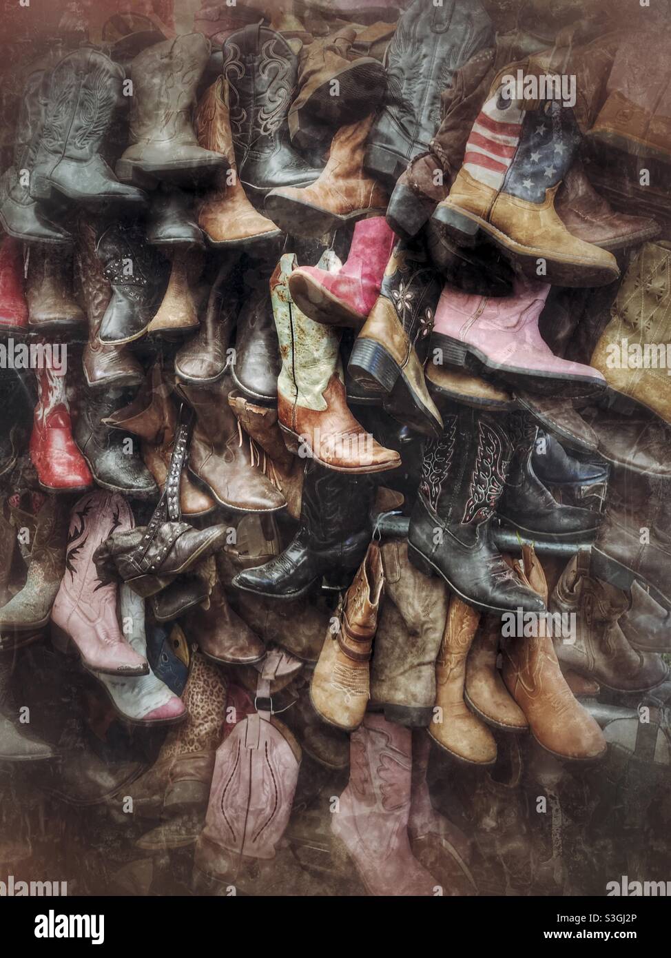Wall of used cowboy boots for sale at vender’s booth Stock Photo