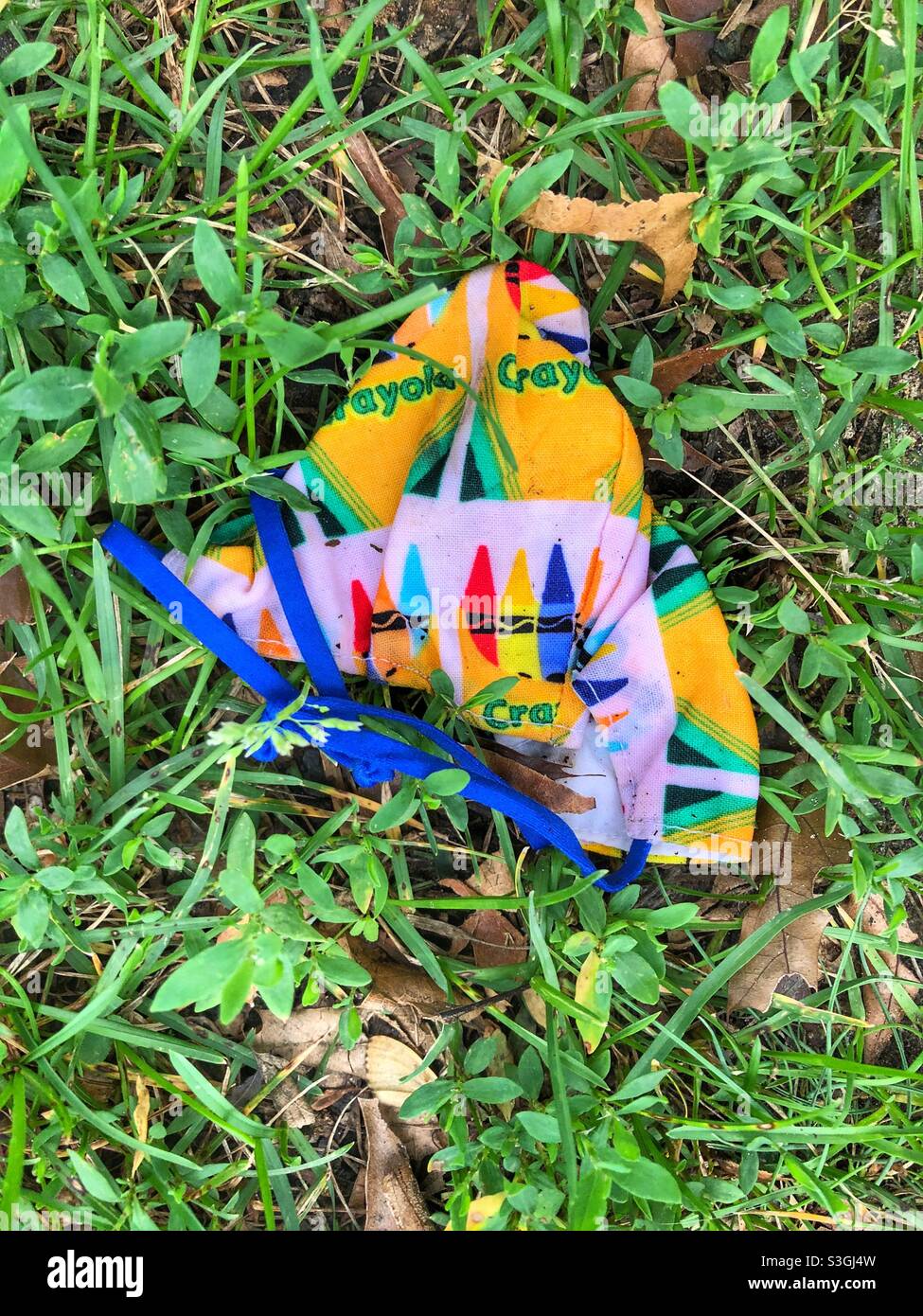 A child’s mask on the grass. Stock Photo