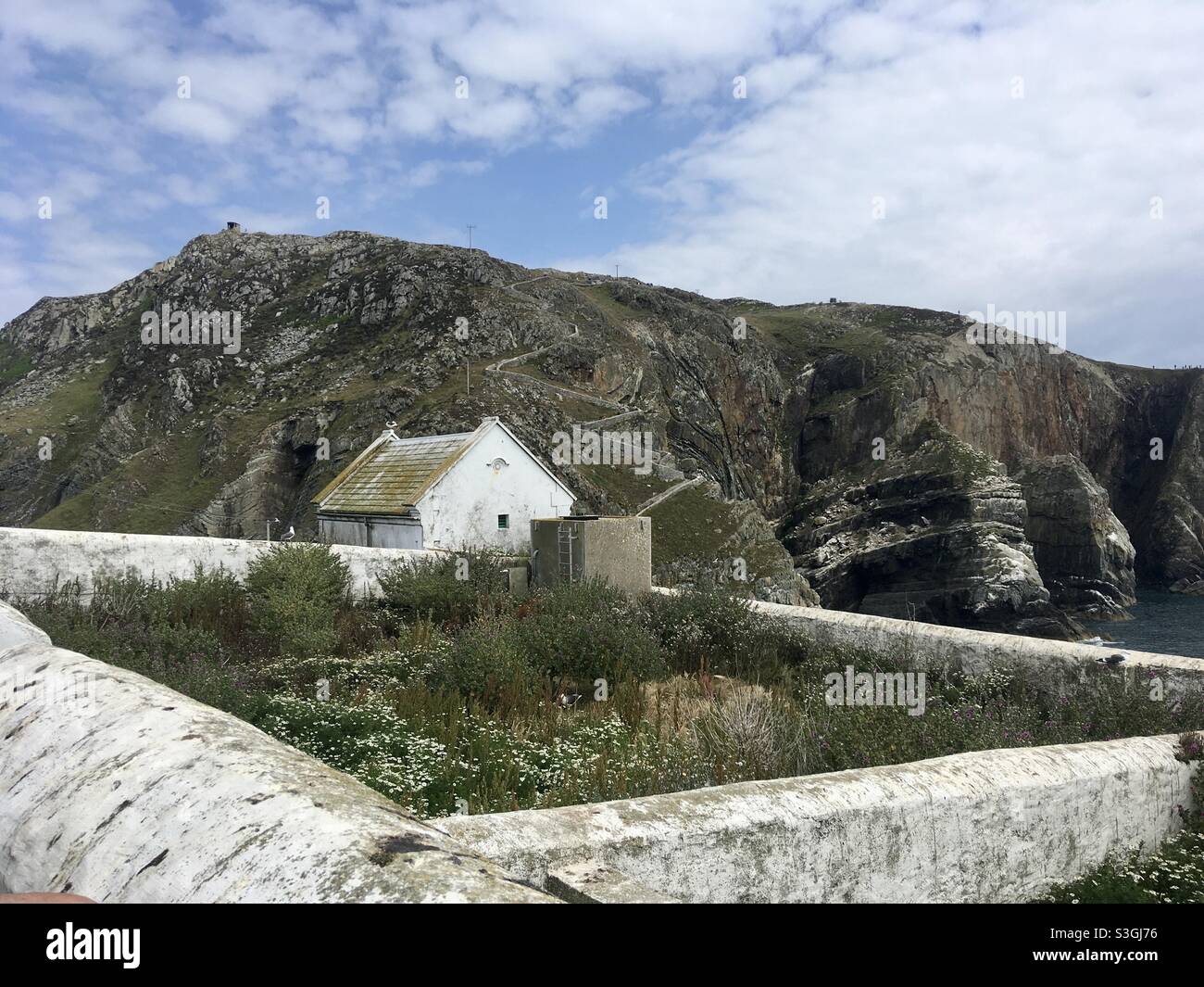 Rugged coastline and part of the lighthouse colony at South Stack, Anglesey, North Wales - Smartphone Captured Stock Image