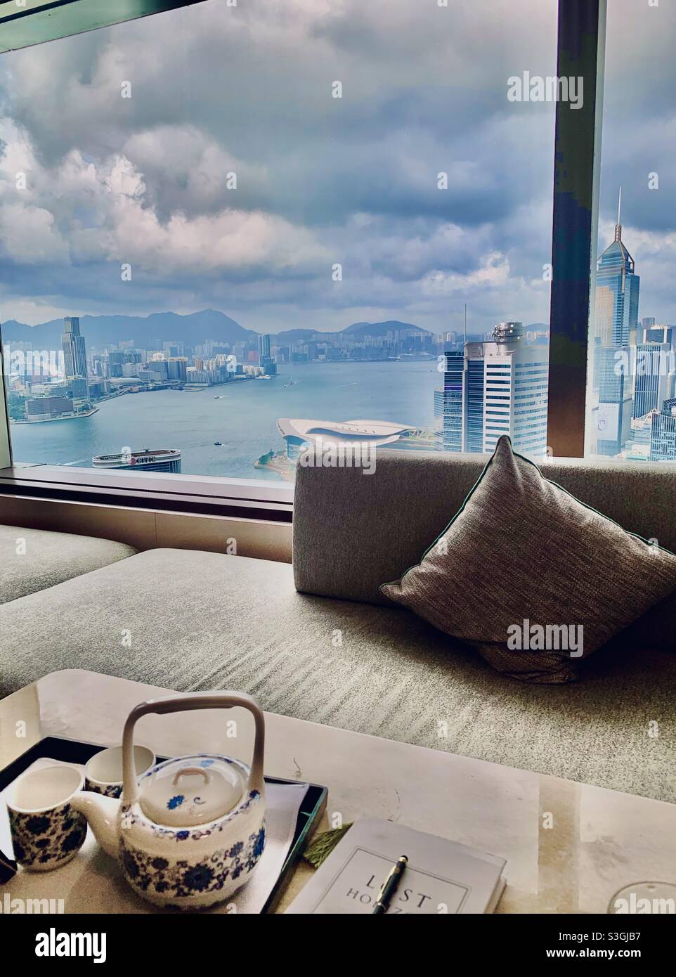 A cup of tea with a view of the Victoria harbour in Hong Kong. Stock Photo
