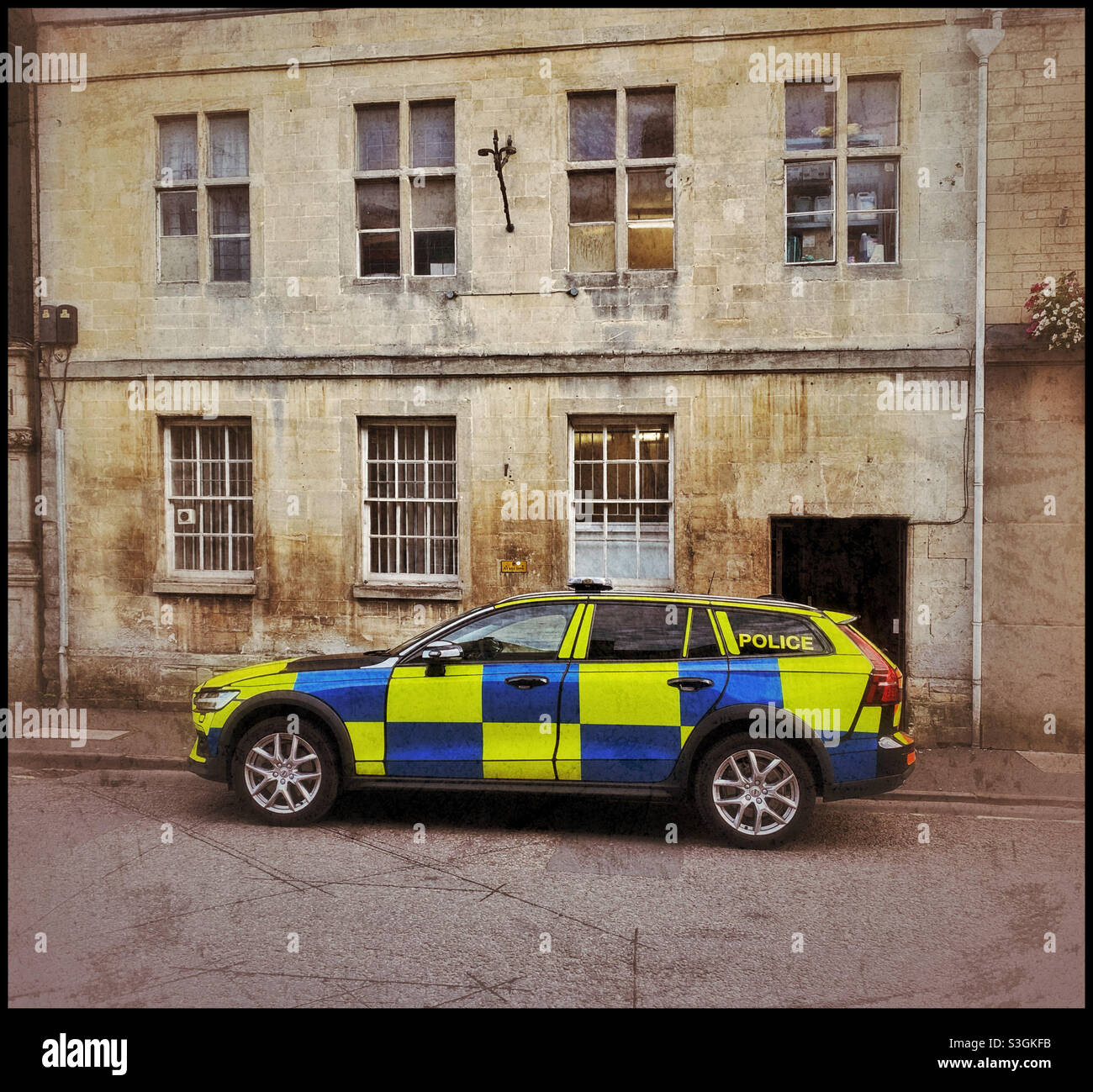 A new and brightly coloured Police car is parked outside an old building somewhere in England. Photo Credit - ©️ COLIN HOSKINS. - Smartphone Captured Stock Image