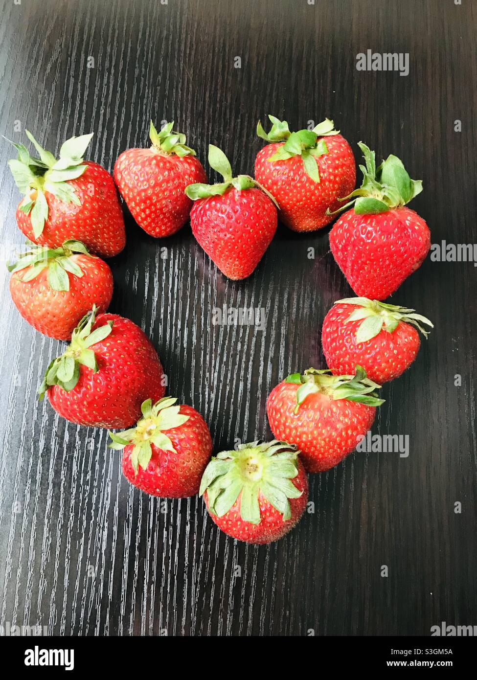 Fruit for a day … heart melted strawberries Stock Photo