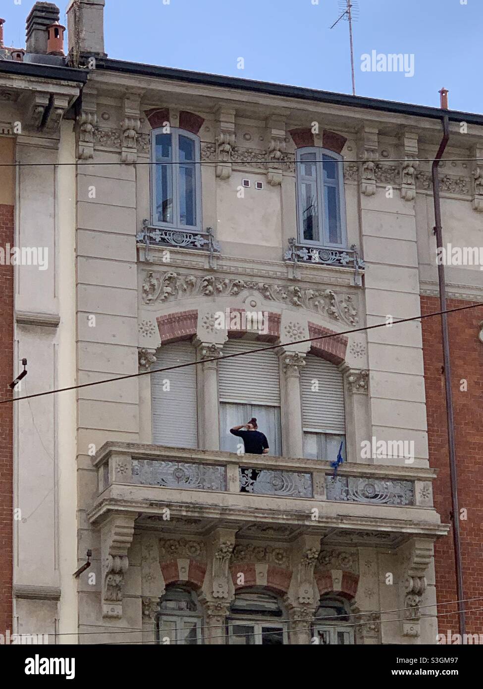 Young woman on a balcony in Milan - Smartphone Captured Stock Image