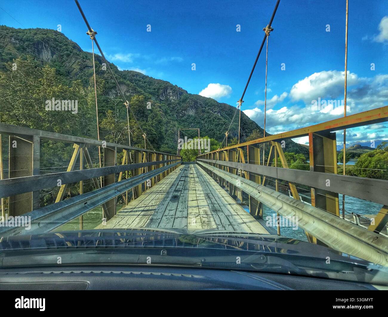 Driving across a rickety wooden one lane bridge near Lake Wanaka, South Island, New Zealand Stock Photo