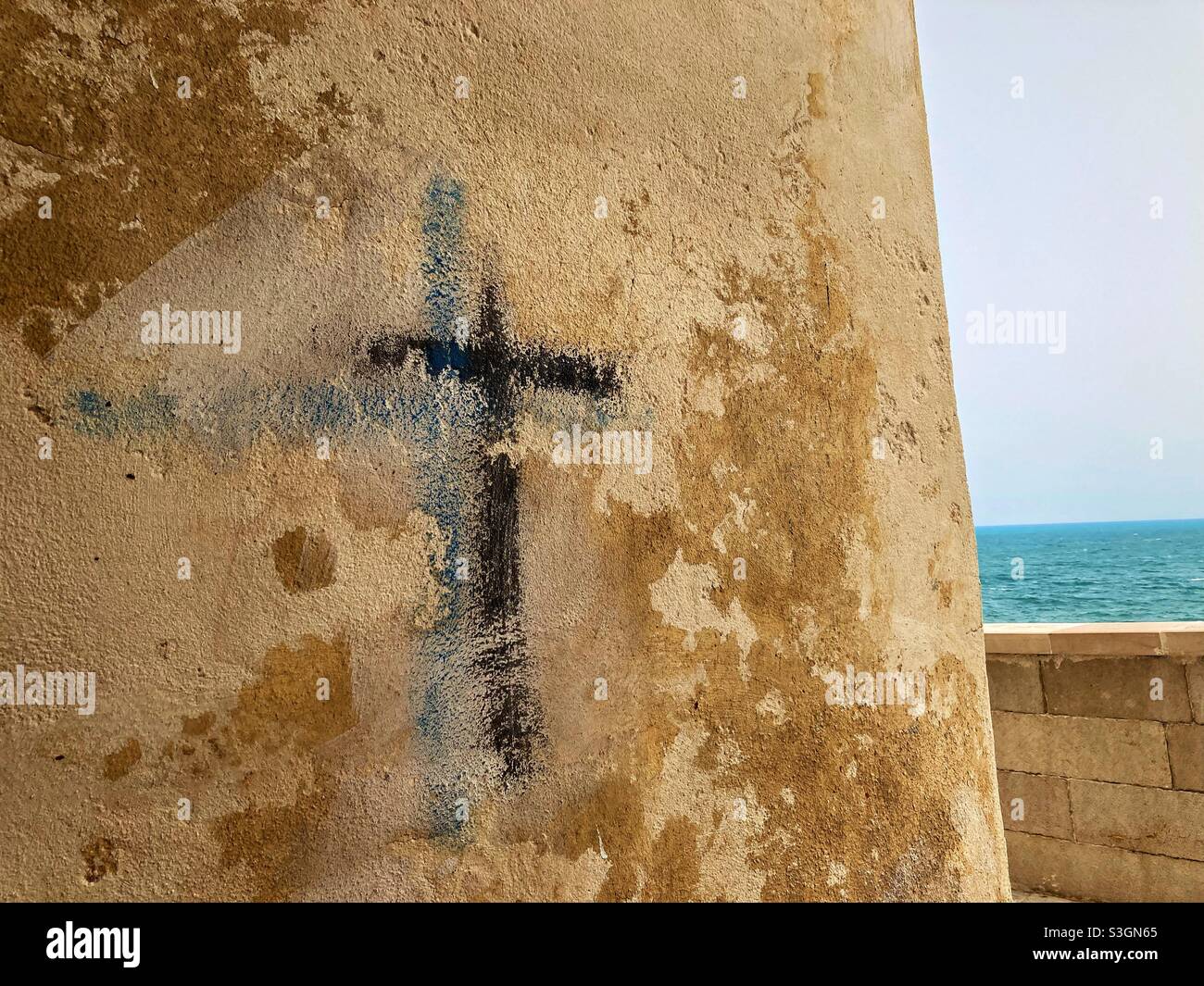 A Cross graffiti drawn on a Wall in an alley in Vieste, Puglia, Italy - Smartphone Captured Stock Image