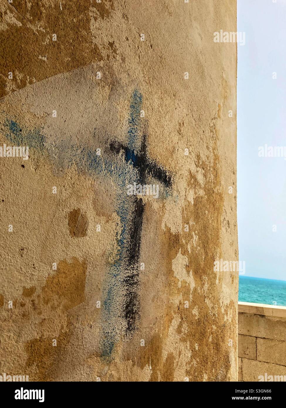 A Cross graffiti drawn on a Wall in an alley in Vieste, Puglia, Italy - Smartphone Captured Stock Image