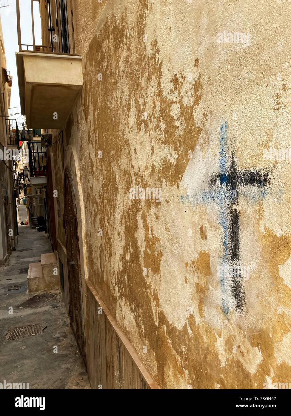 A Cross graffiti drawn on a Wall in an alley in Vieste, Puglia, Italy - Smartphone Captured Stock Image