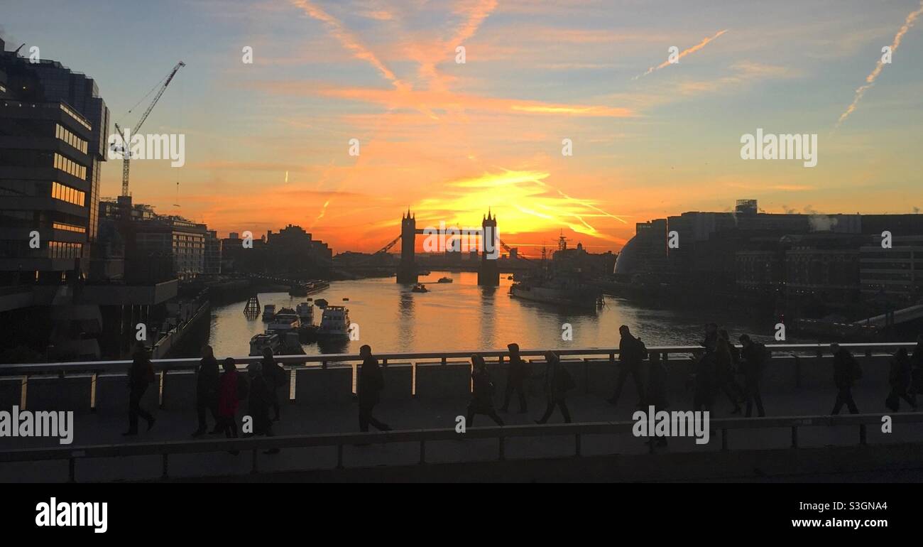 Commuters on London Bridge at sunrise Stock Photo