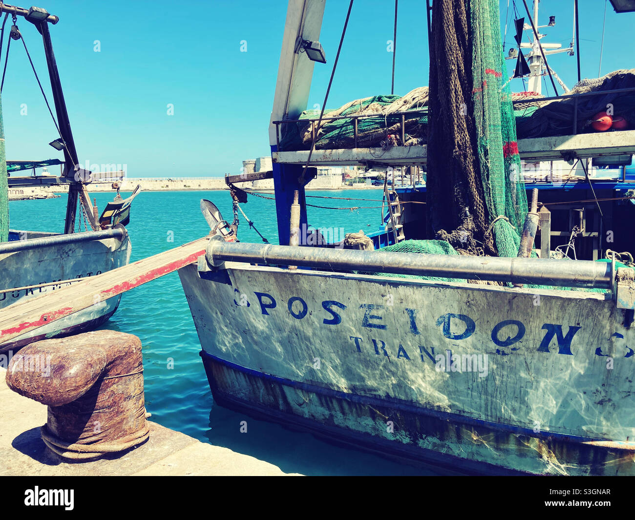 A fishing vessel und the apulian town of Trani, Italy - Smartphone Captured Stock Image