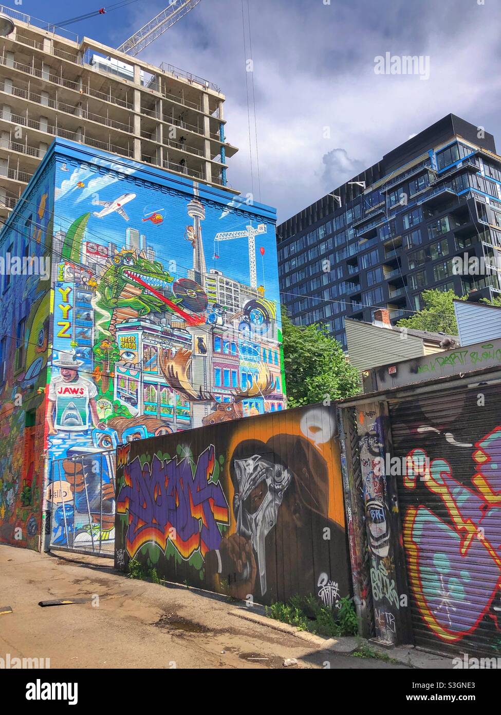 Urban street art murals in graffiti alley in a Toronto neighbourhood. - Smartphone Captured Stock Image