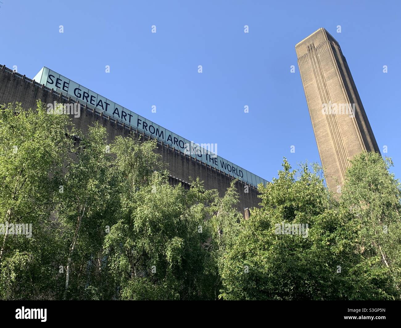 Tate Modern in London on a sunny day. Shows the Tate Modern’s slogan “See great art from around the world” Stock Photo