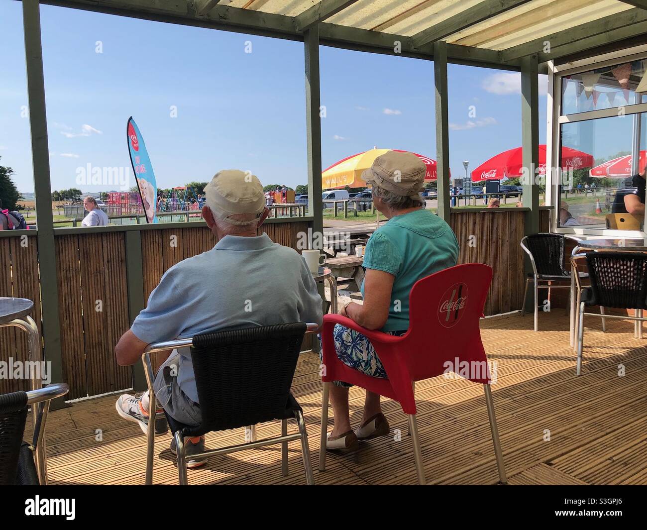 Seniors having coffee on a veranda Stock Photo Alamy