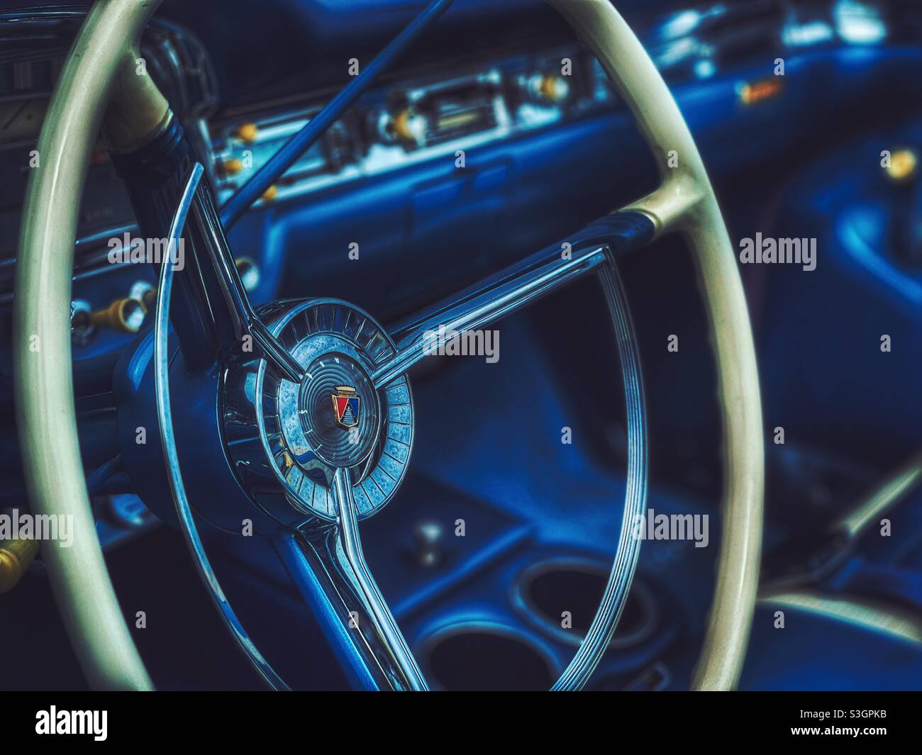 Moody image of a vintage automobile dashboard and steering wheel Stock Photo