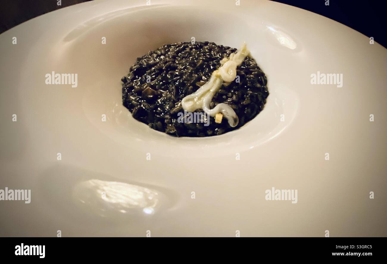 squid ink risotto in Venice, Italy Stock Photo