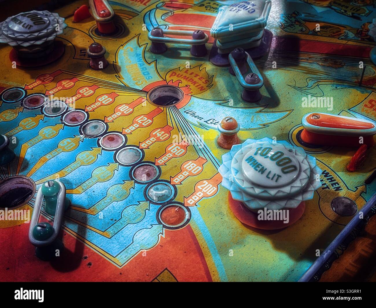 Closeup of a colorful retro pinball machine playing field - Smartphone Captured Stock Image