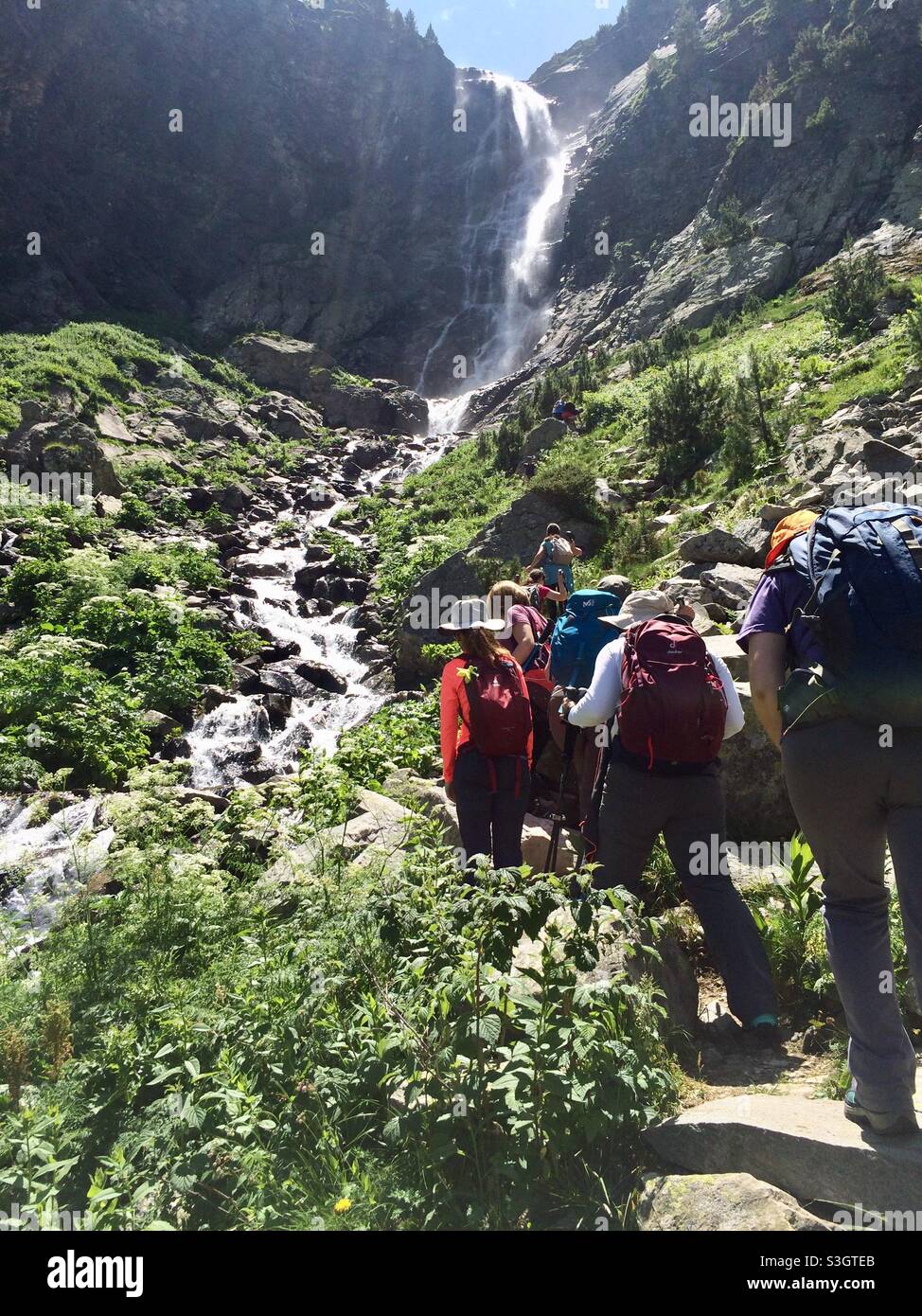 Hiking in Bulgaria. Hikers on a path at the Skakavitsa waterfall in Skakavitsa Nature Reserve in Rila National Park, Bulgaria, Balkans, Europe - Smartphone Captured Stock Image