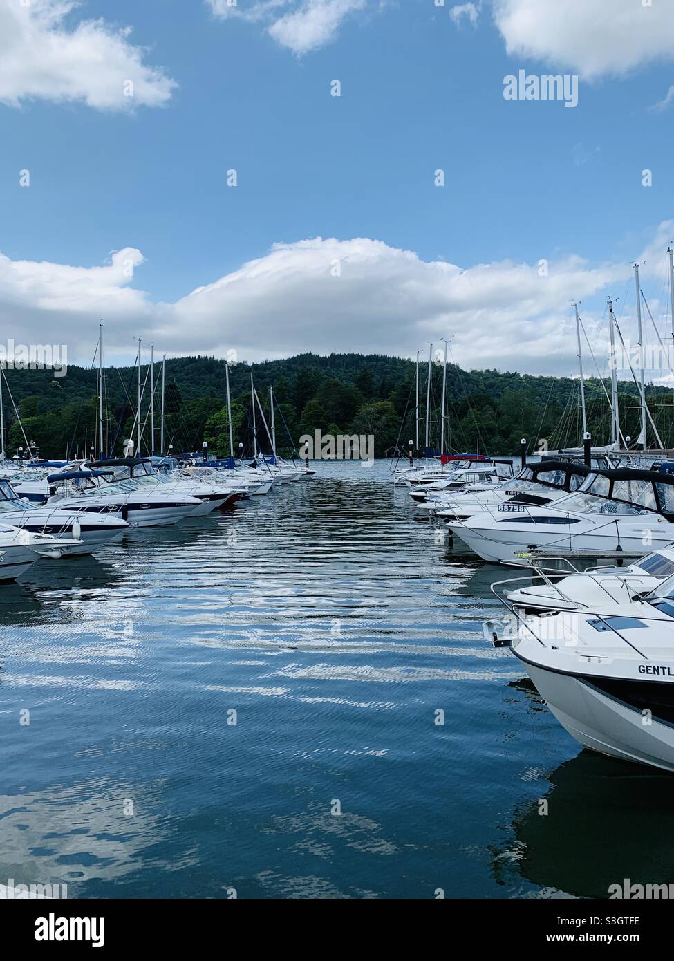 Boats lined up on lake Windermere marina Stock Photo Alamy