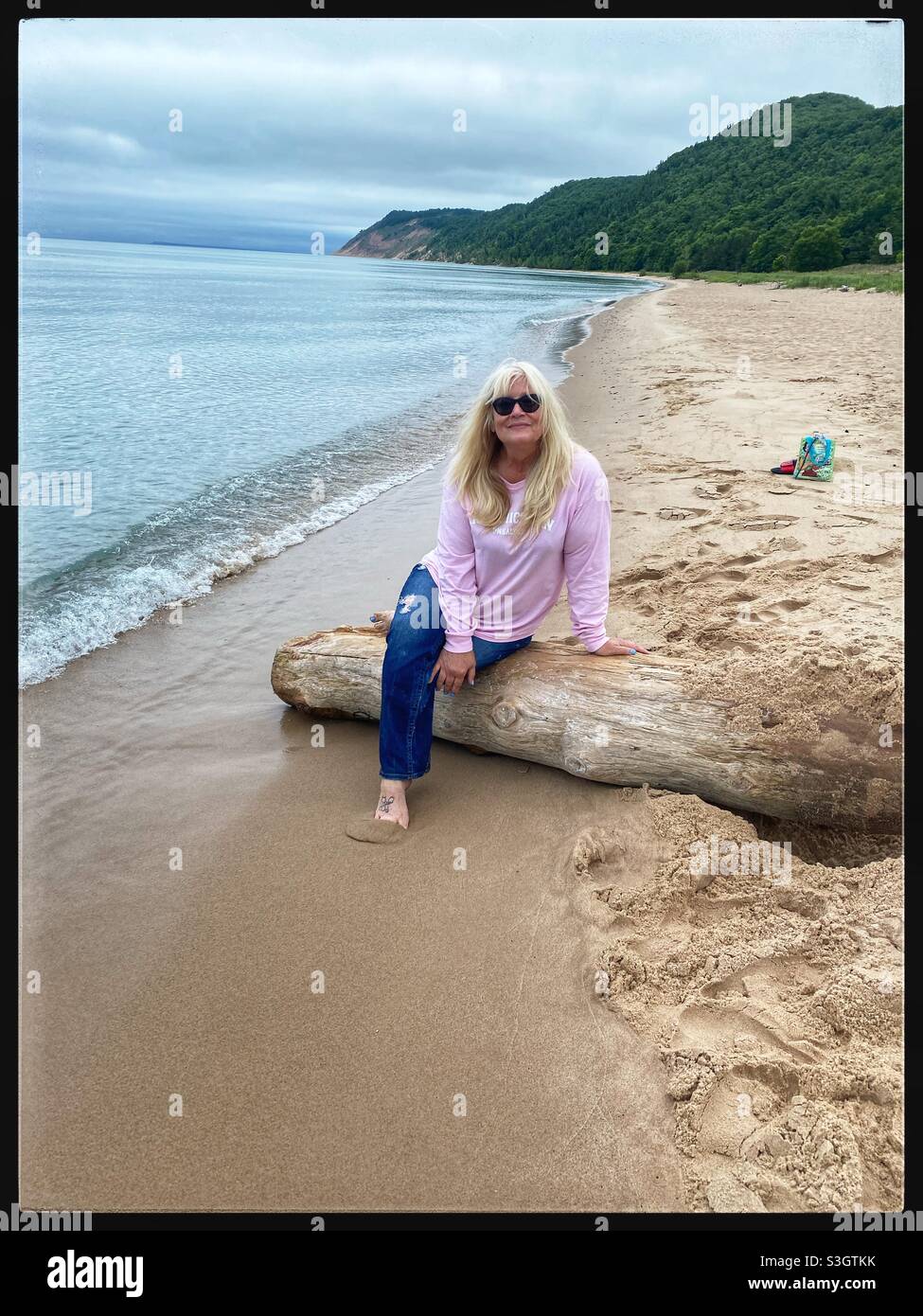 Woman in pink on the beach Stock Photo