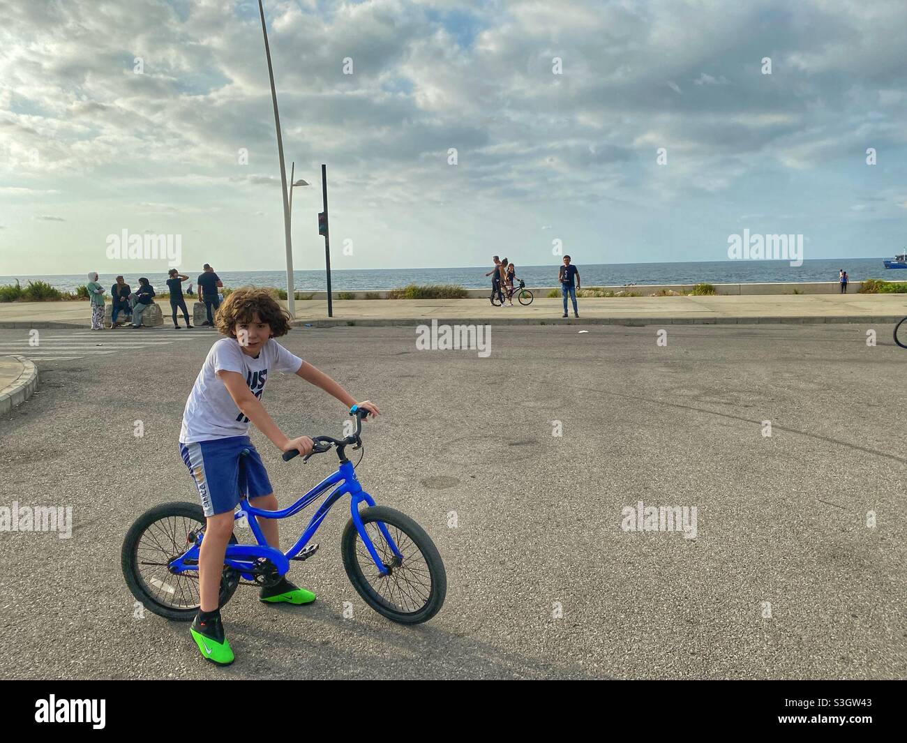 11 years boy riding a bike at Beirut Lebanon water front Stock Photo