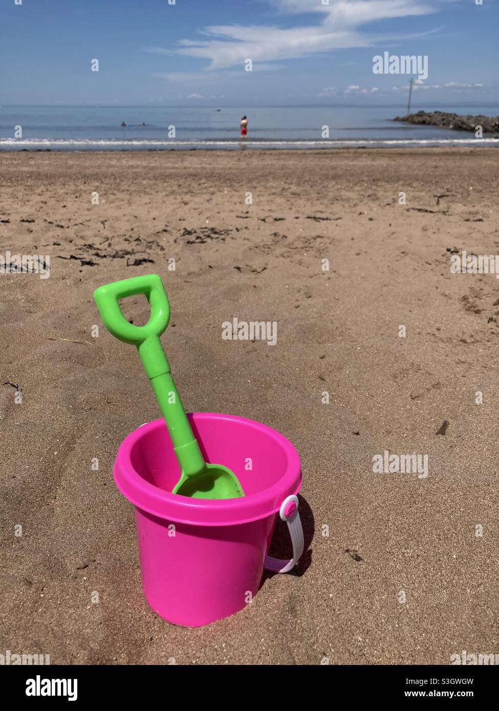 Minehead beach , Devon - bucket & spade in the sand with the sea in the distance Stock Photo