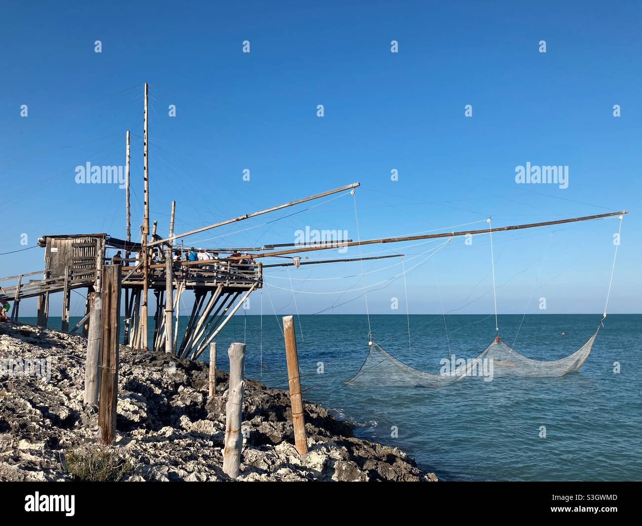 A demonstration of fishing with a Traditional Trabucco on the Coast near the Apulian town Vieste, Gargano, Puglia, Italy - Smartphone Captured Stock Image