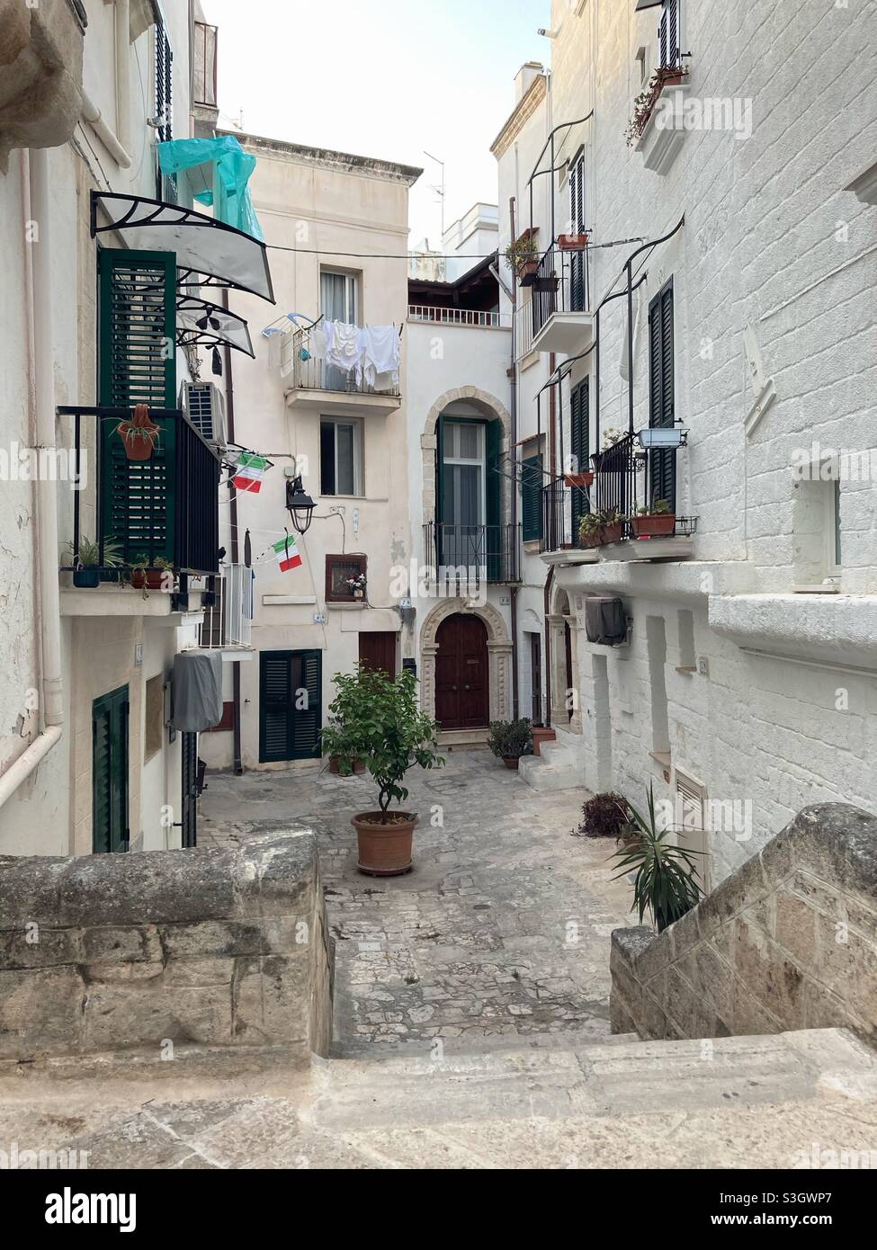 A Small alley or courtyard in the Apulian city Monopoli, Puglia, Italy - Smartphone Captured Stock Image