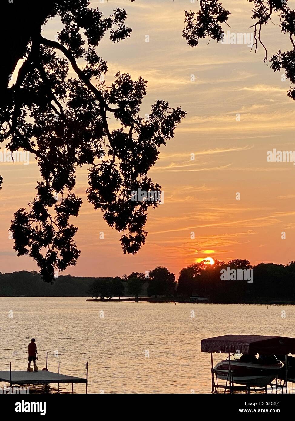 Fishing while the sun goes down in Lake Catherine, Illinois Stock Photo