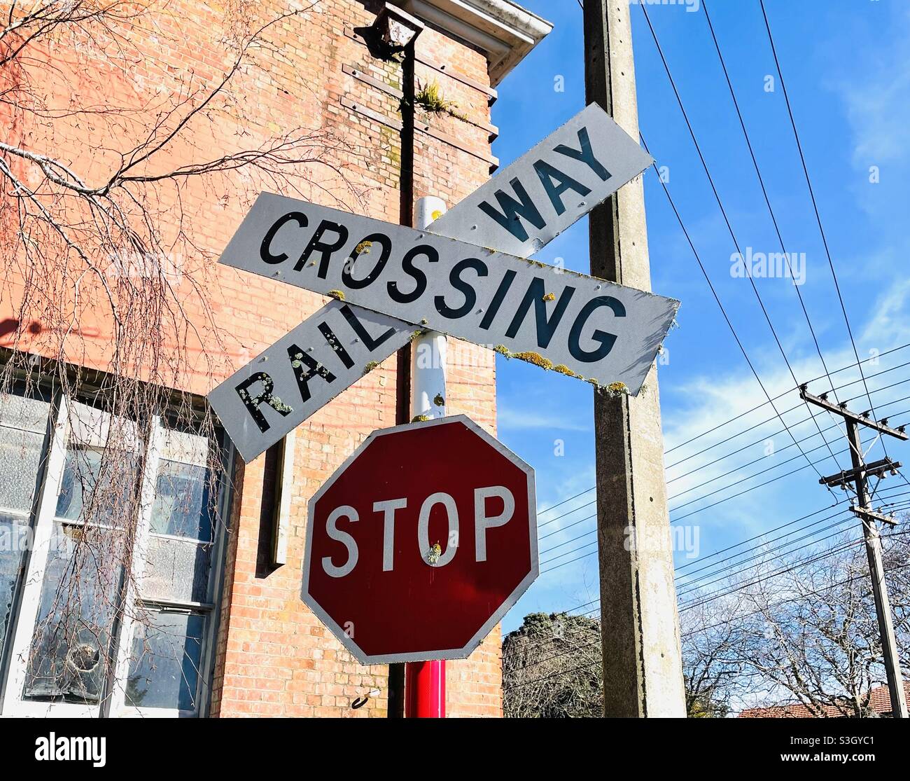 Railway crossing and stop traffic sign in Whanganui New Zealand - Smartphone Captured Stock Image