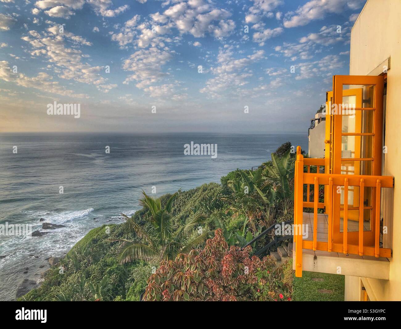 Yellow shutters and cloudy sky, Ballito, South Africa - Smartphone Captured Stock Image