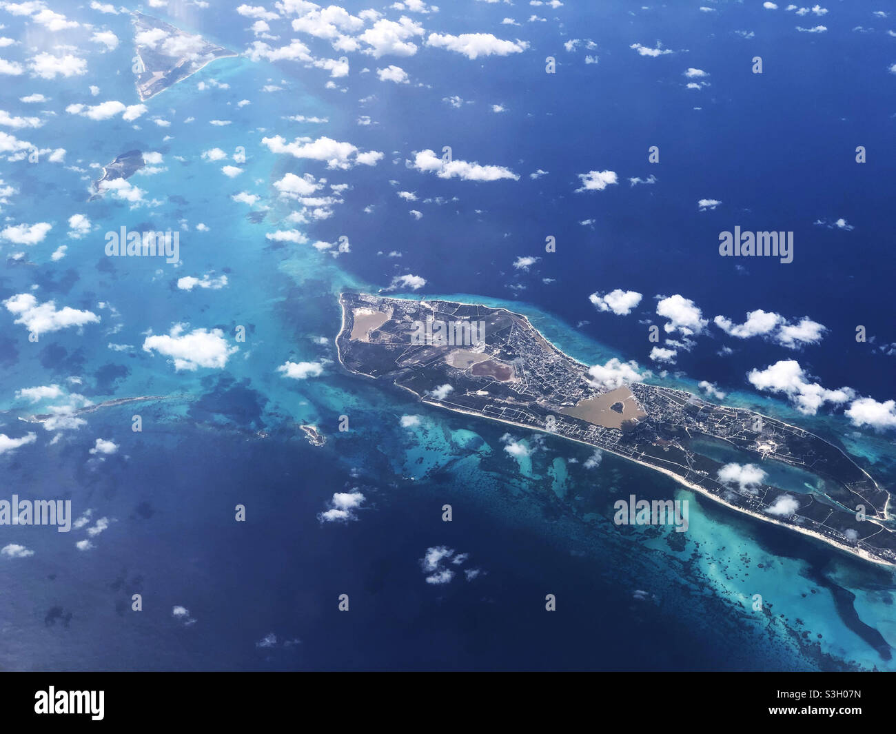 High angle aerial view on a clear day with view of Grand Turk, the reefs and the clear water in the Caribbean Sea - Smartphone Captured Stock Image