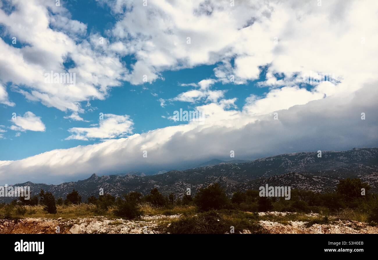 Clouds rolling from the mountains Stock Photo