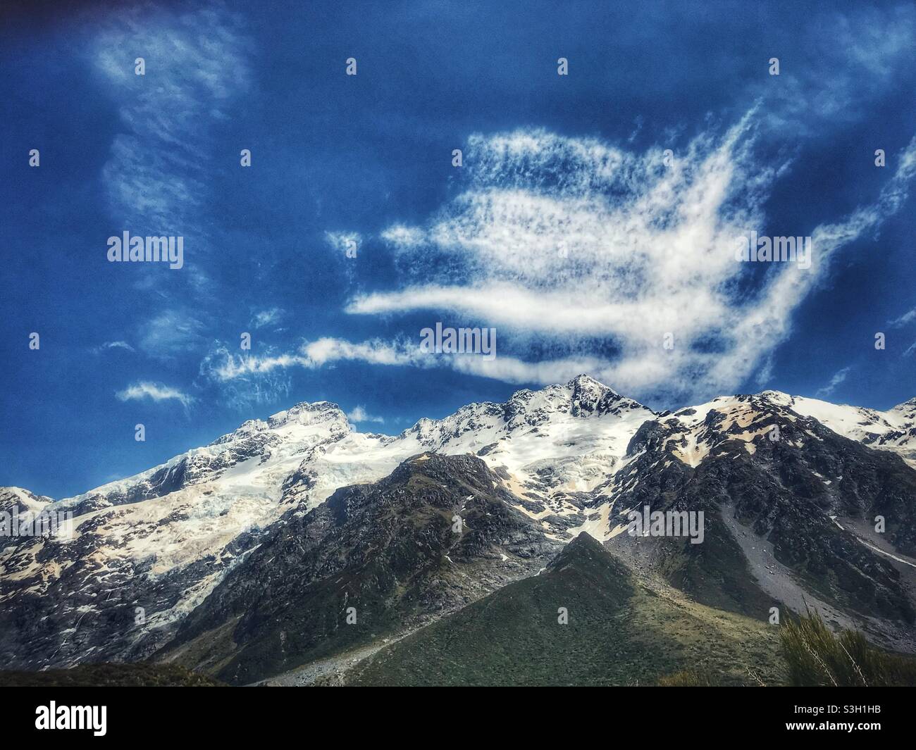 Clouds over a snowy peak in the Aoraki Mount Cook National Park, Canterbury region, South Island, New Zealand Stock Photo