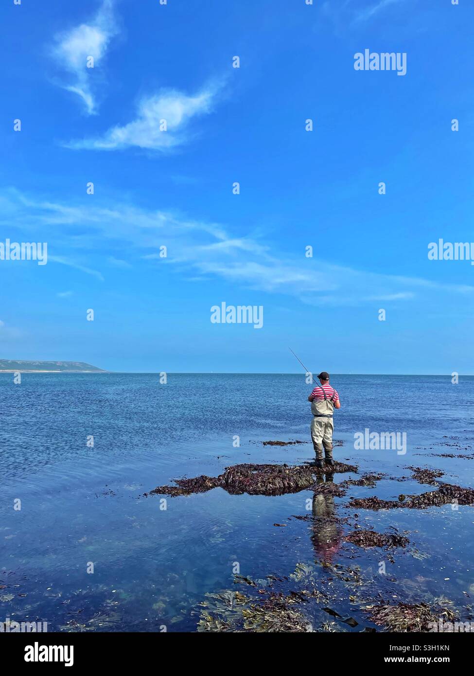 Angler on the Welsh coast at Port Eynon, Gower. - Smartphone Captured Stock Image