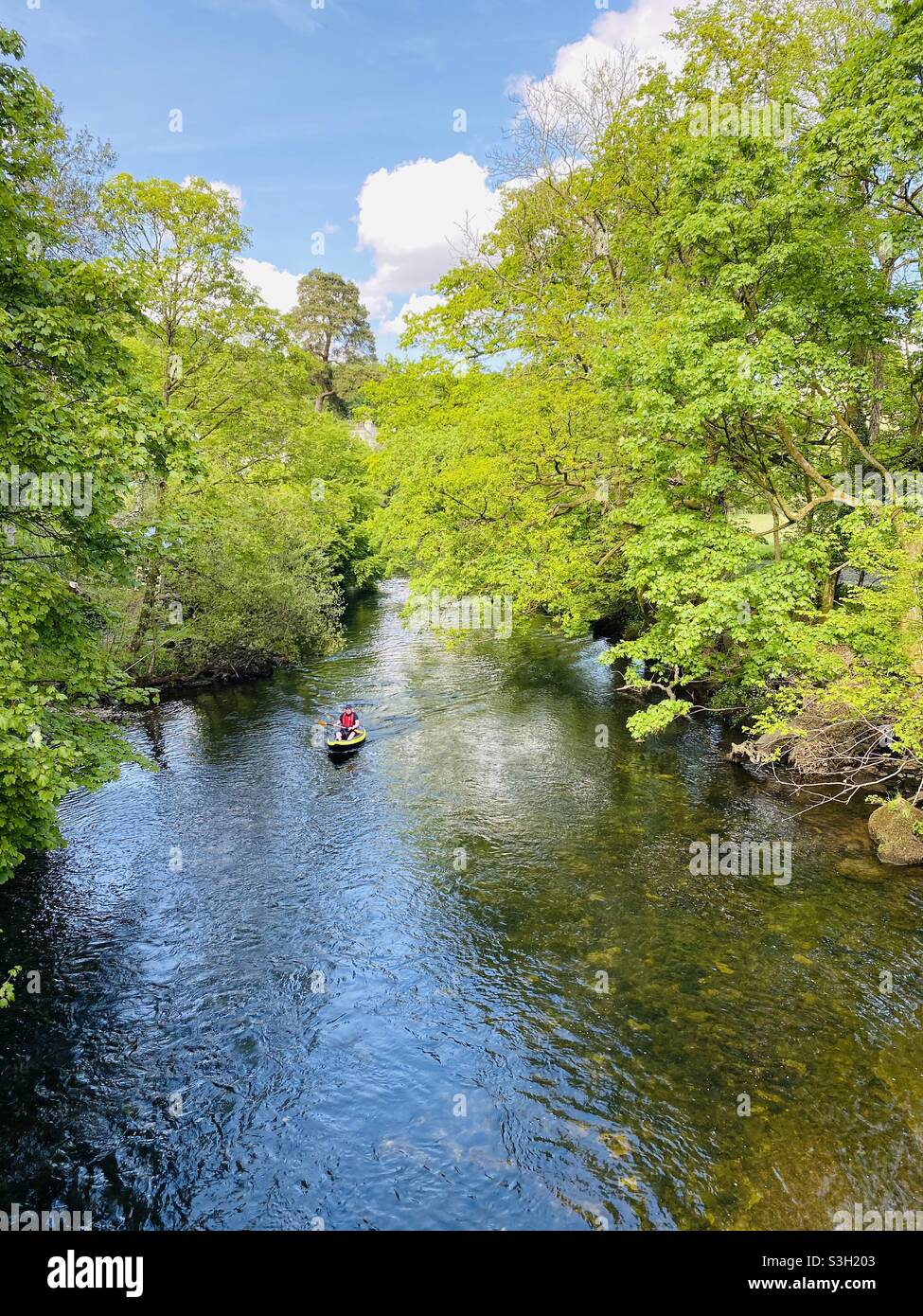 Canoeing down the River Brathay on a warm summers day Stock Photo
