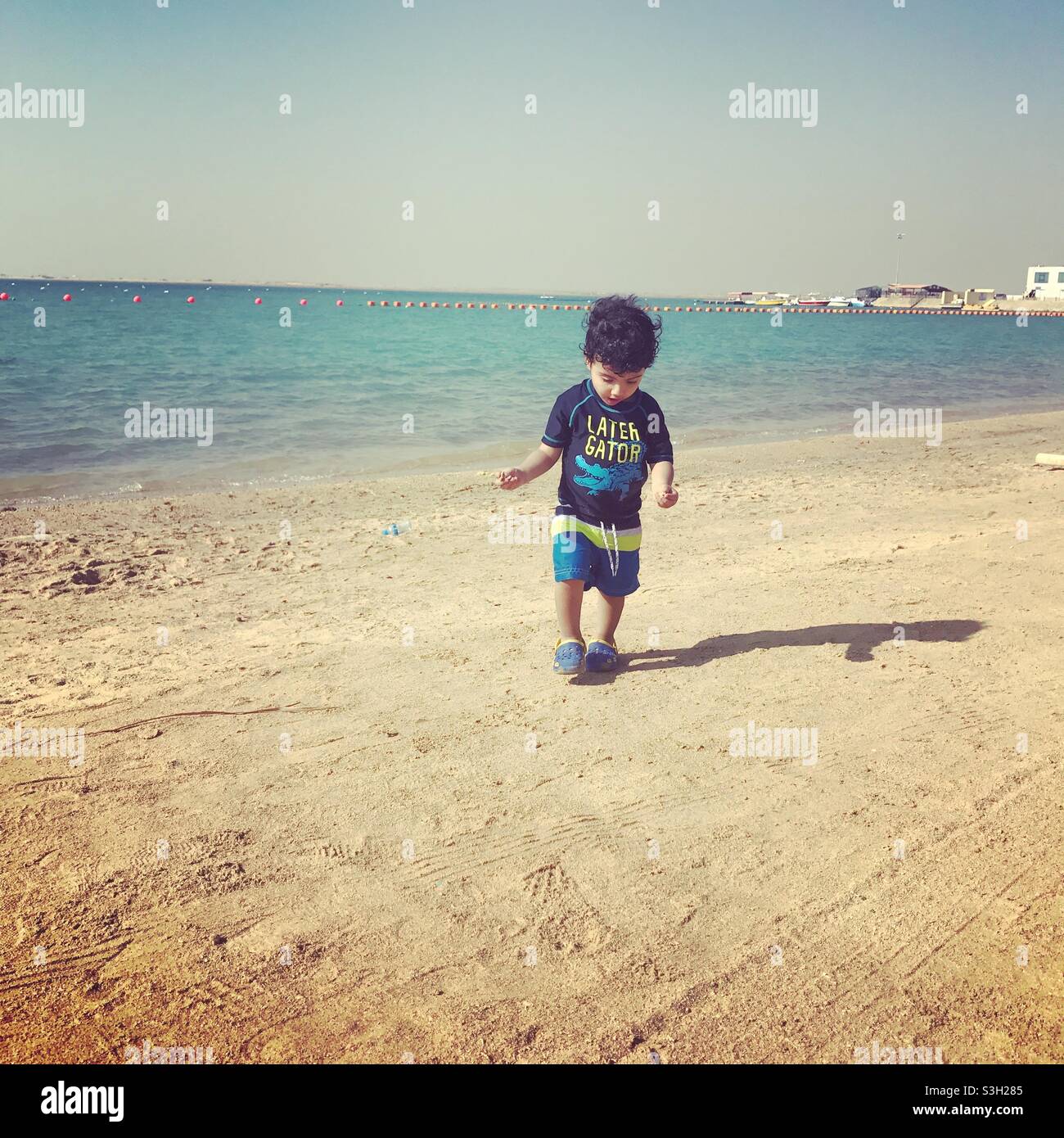 The boy was walking on the beach in Jeddah city. Stock Photo