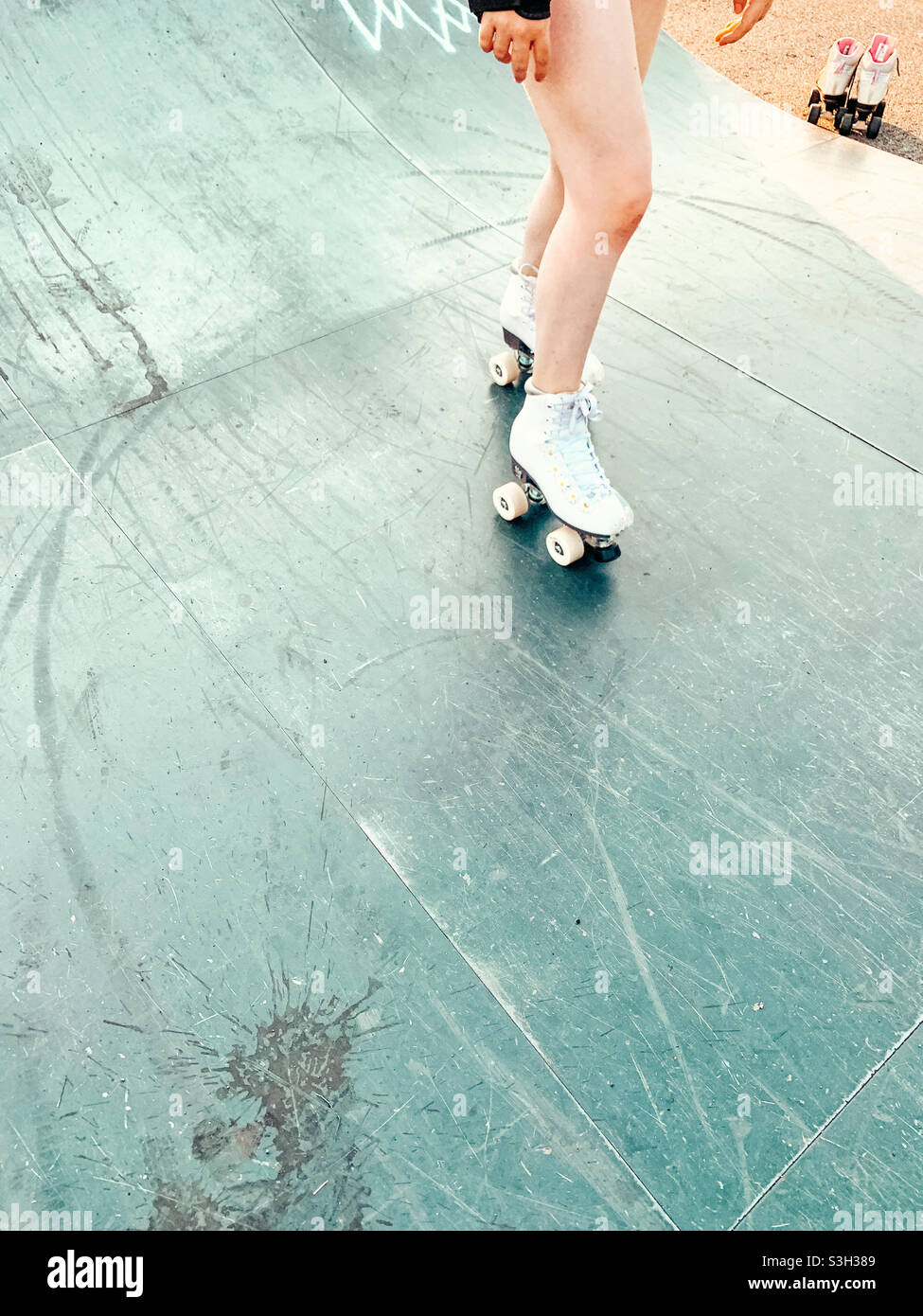 Young female roller skating on ramp Stock Photo