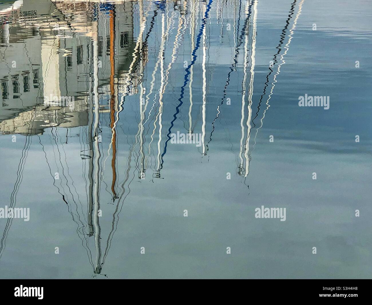 Boat masts reflecting in the water - Smartphone Captured Stock Image