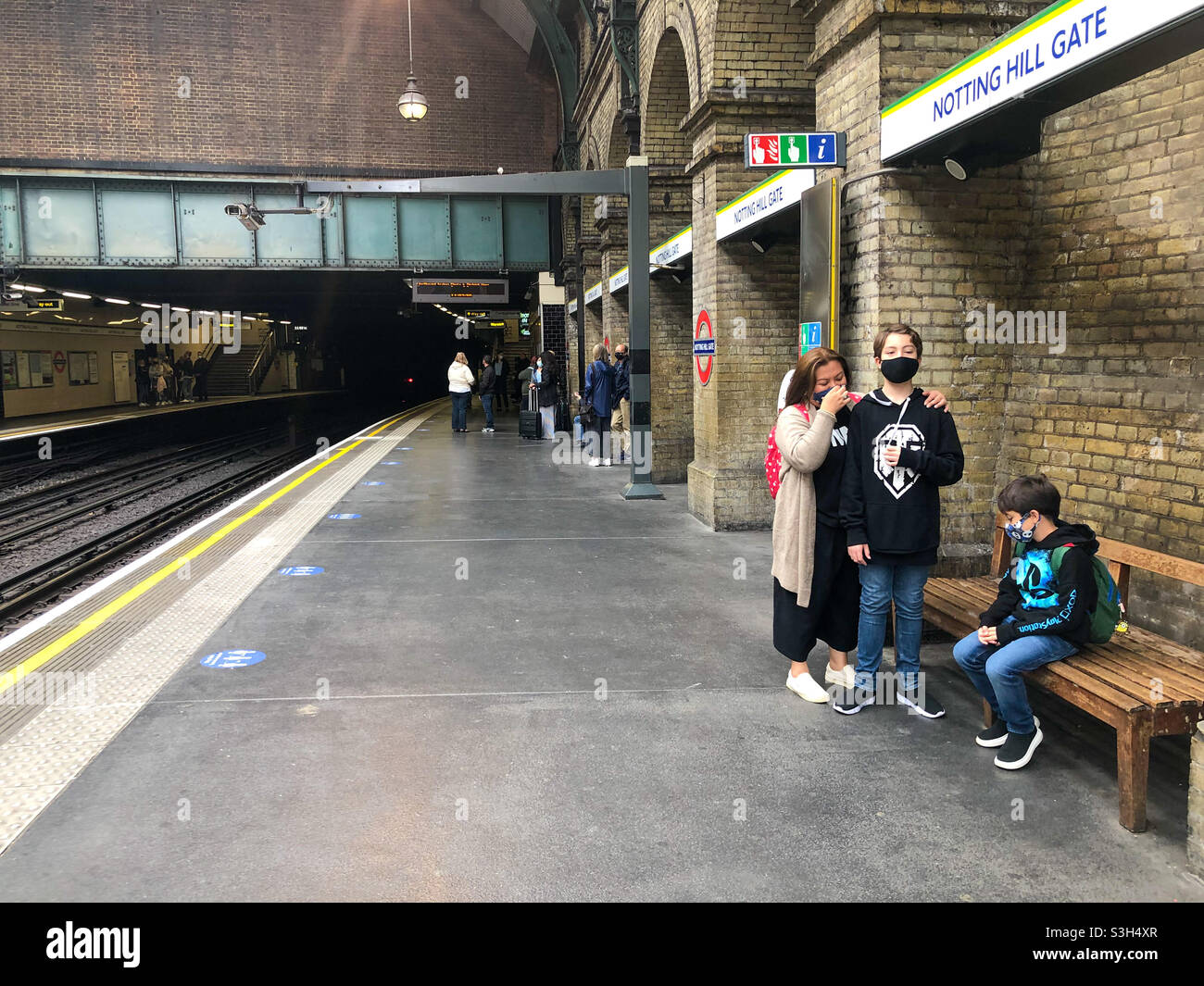 Passengers wait in the platform at Notting Hill Gate London Underground Station: - Smartphone Captured Stock Image