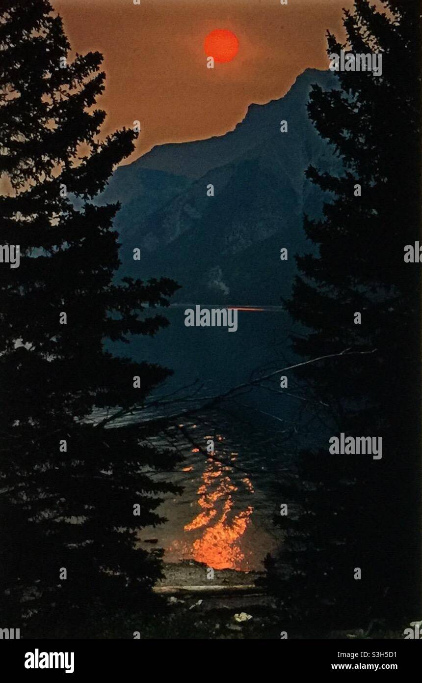 Smoky sunrise, Lake Minniwanka, Banff National Park, forest fires, global warming, mountains, Rockies, - Smartphone Captured Stock Image