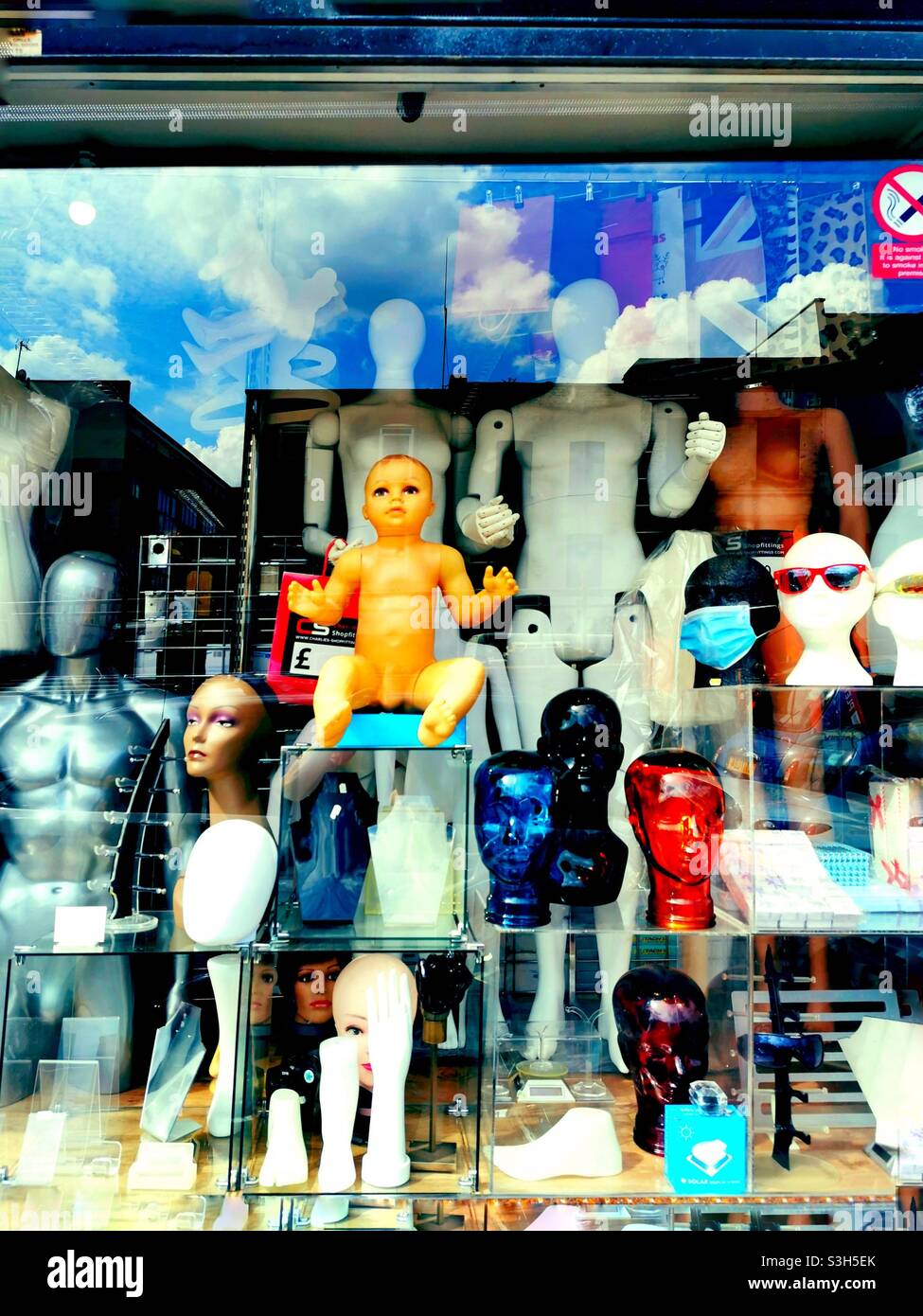 saturated shop window with mannequins and reflection Stock Photo