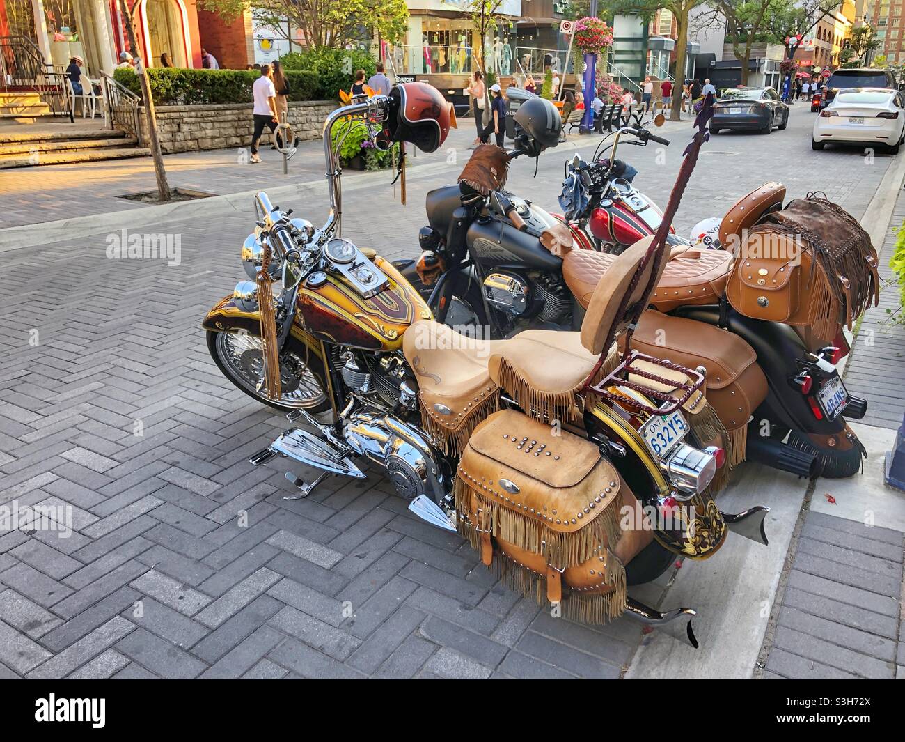 Three motorcycles parked in Yorkville, a Toronto downtown Toronto neighbourhood. - Smartphone Captured Stock Image